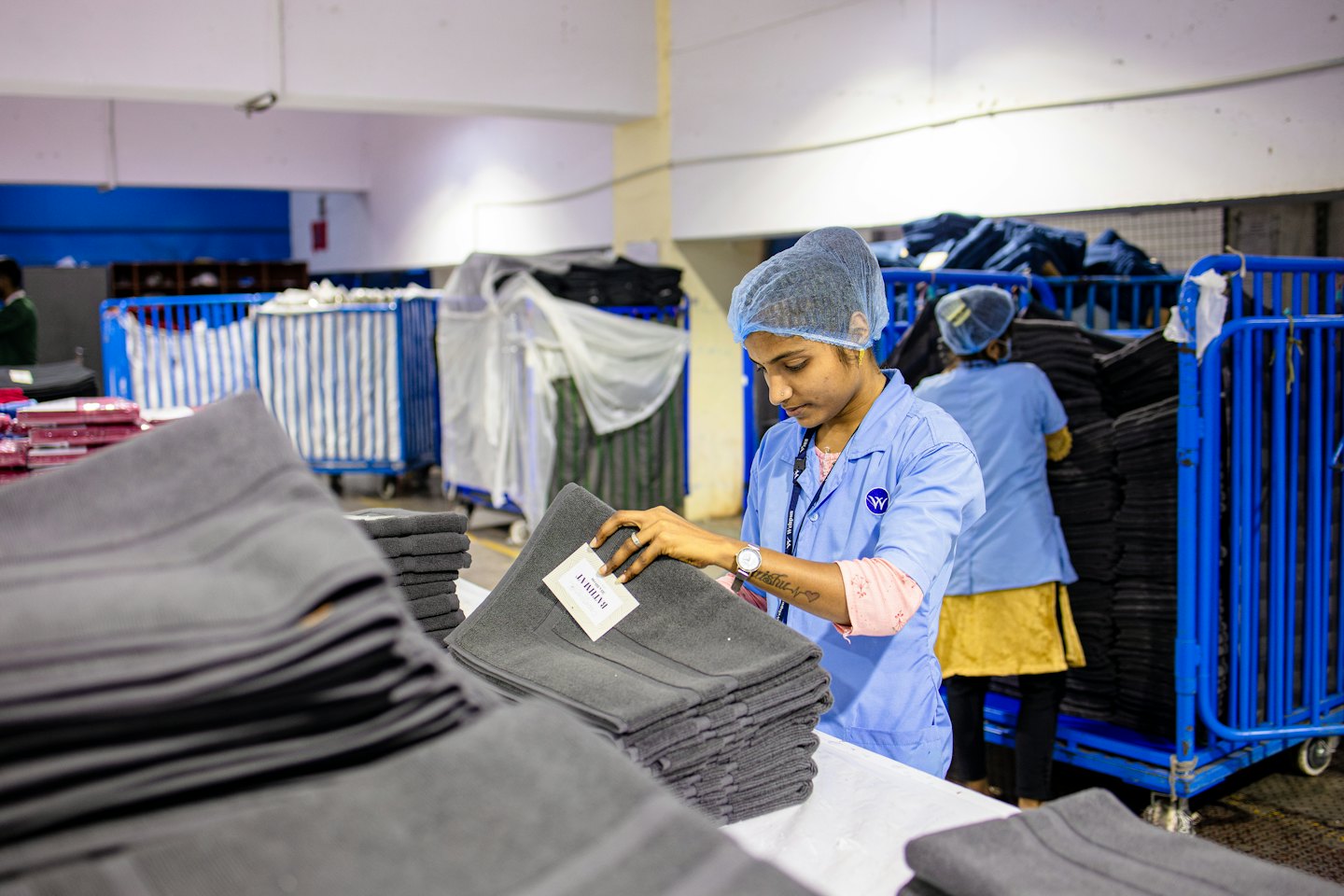 Woman inspects textile quality in a factory.